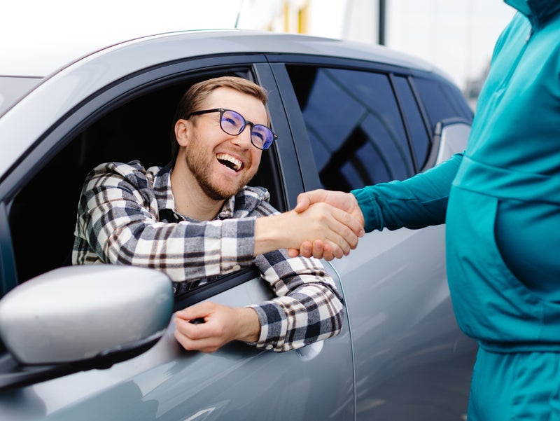 Customer being greeted with a smile on their face- DeVoe Cadillac in Naples FL