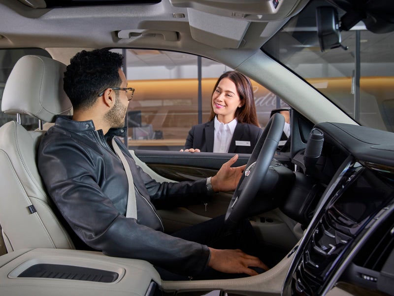 Customer being attended by staff member- DeVoe Cadillac in Naples FL