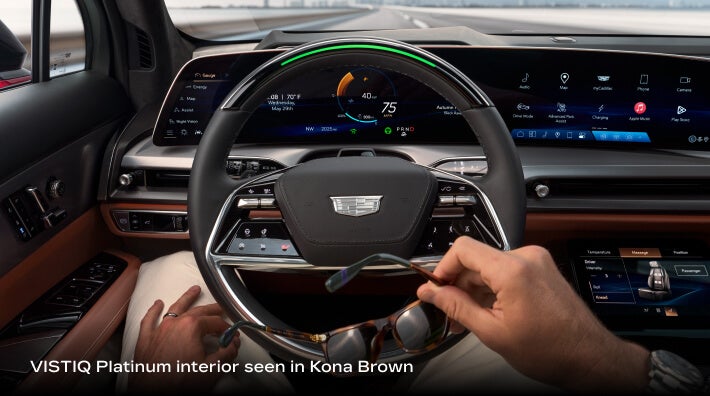 2027 Cadillac VISTIQ Platinum with Kona Brown interior, Super Cruise active and head-up display on the digital cockpit.