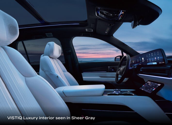 2027 Cadillac VISTIQ Luxury with Sheer Gray interior, side view highlighting ambient lighting across the cabin.