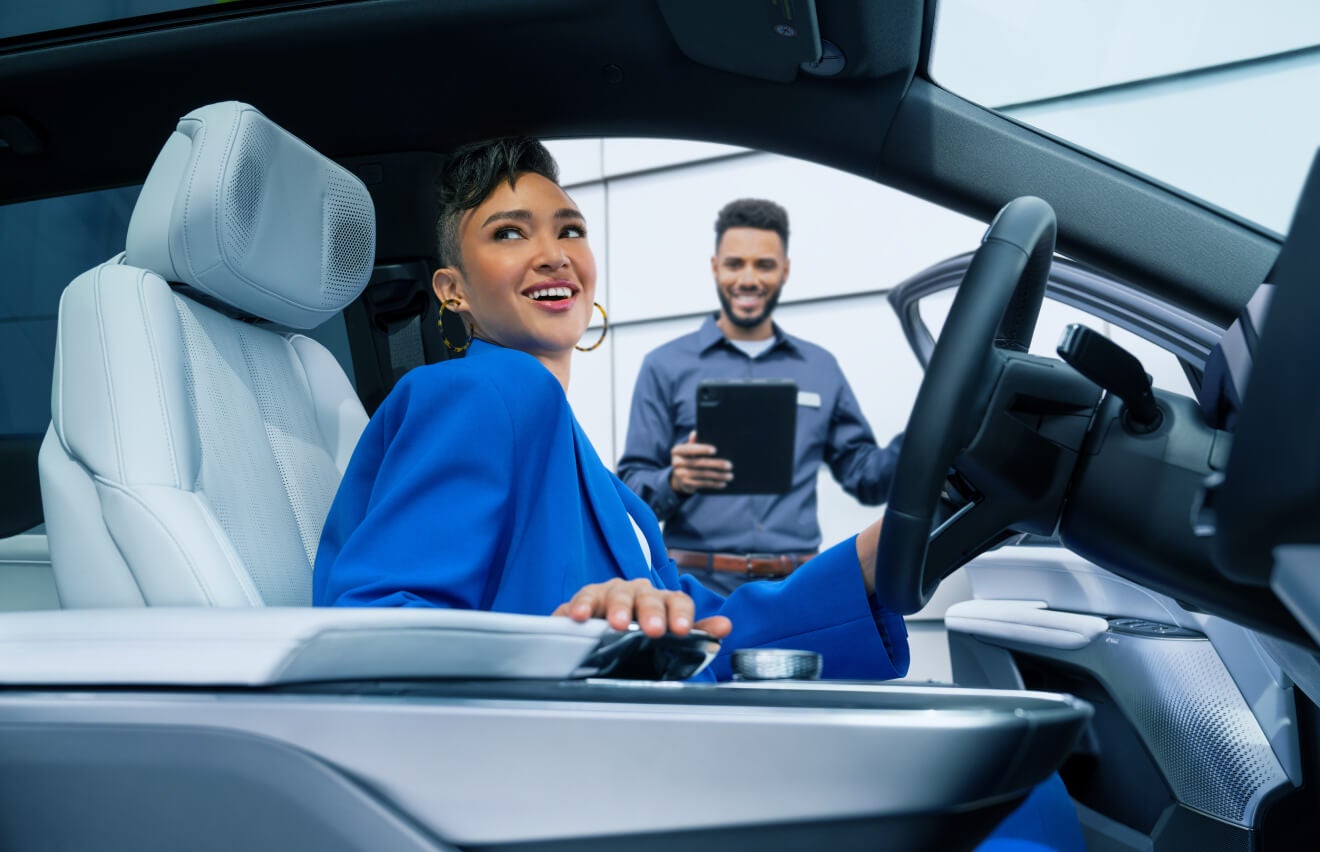 Cadillac Service Technician helping a customer